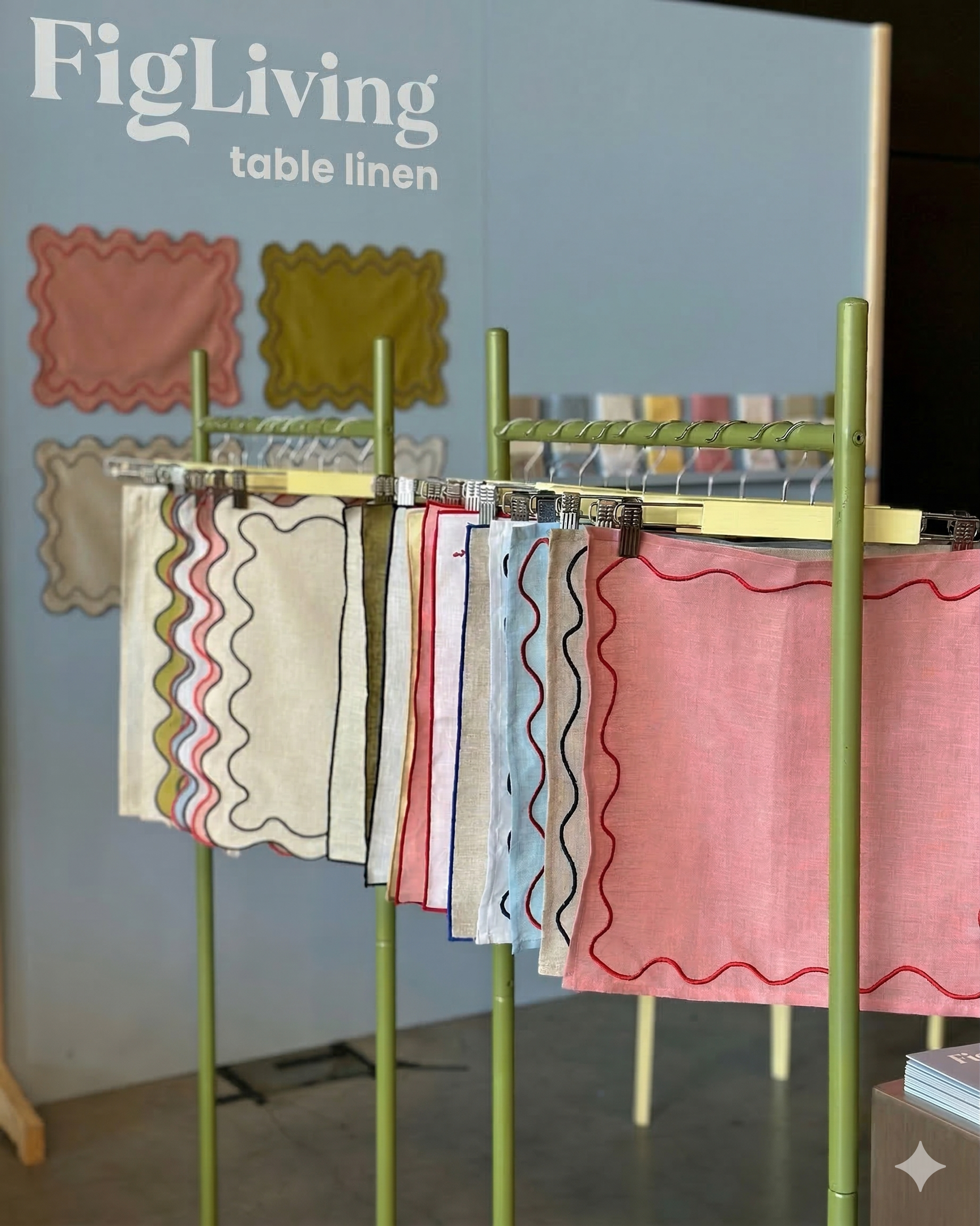 FigLiving exhibition booth showcasing table linen collection with scallop-edge napkins