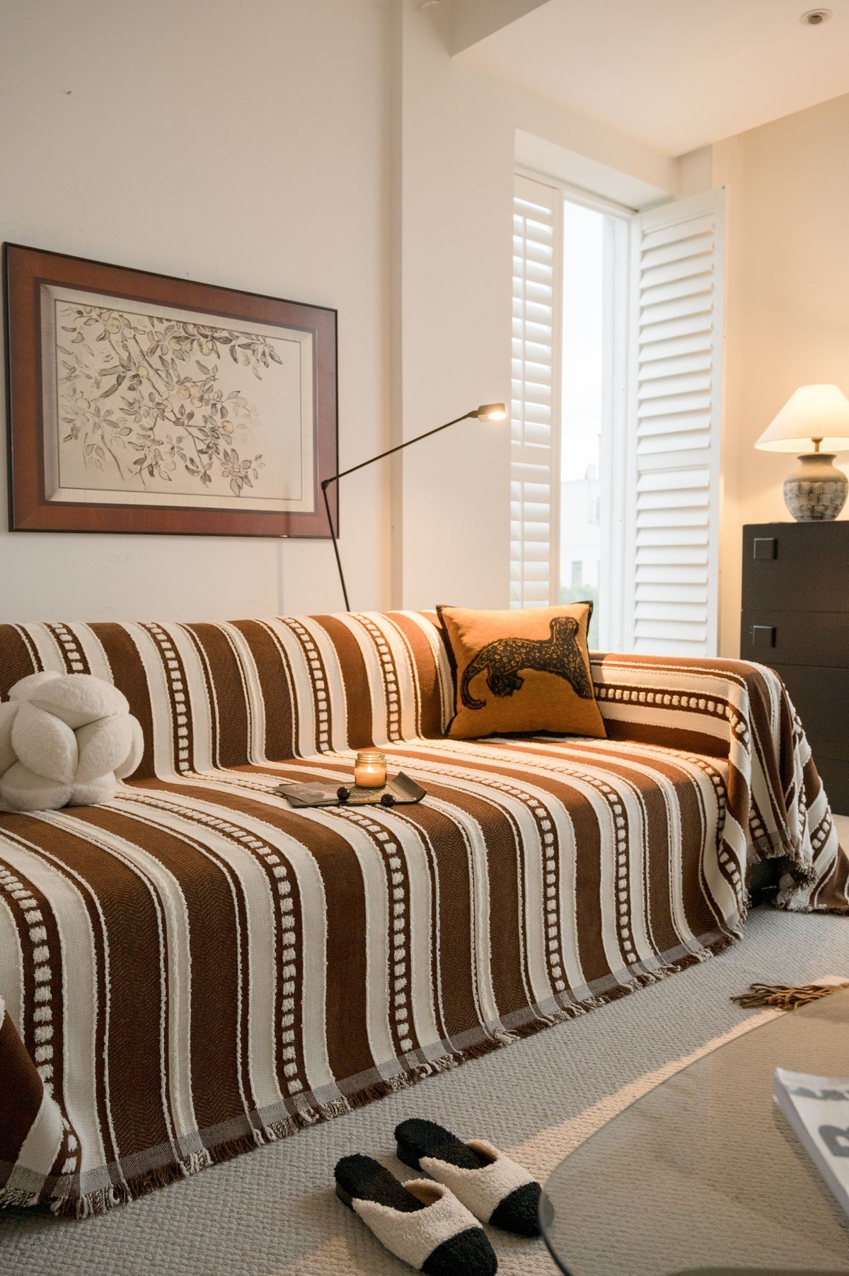 Handloom striped sofa cover draped over couch